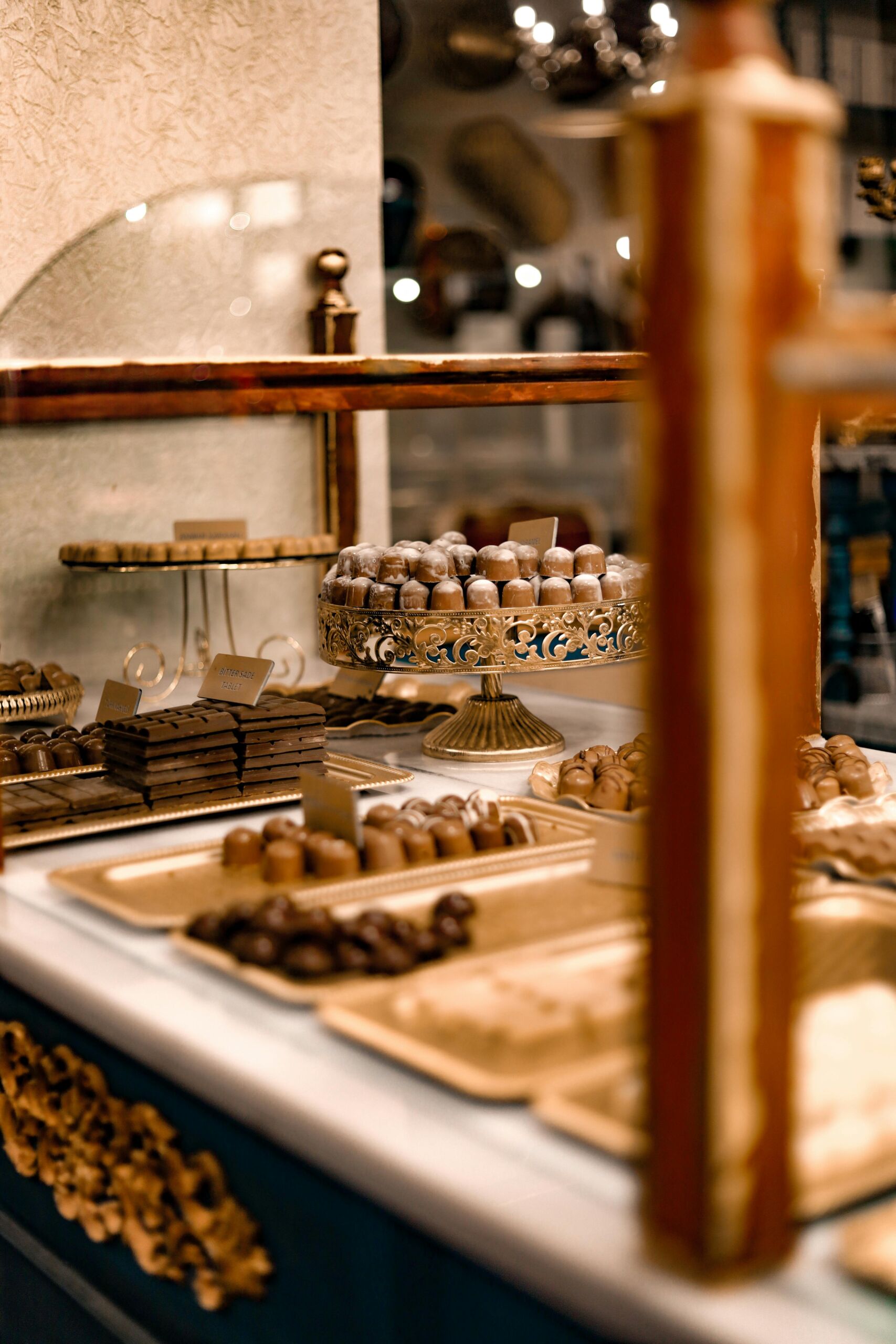 Delicious chocolate treats elegantly displayed on a pastry stand in a luxurious café setting.