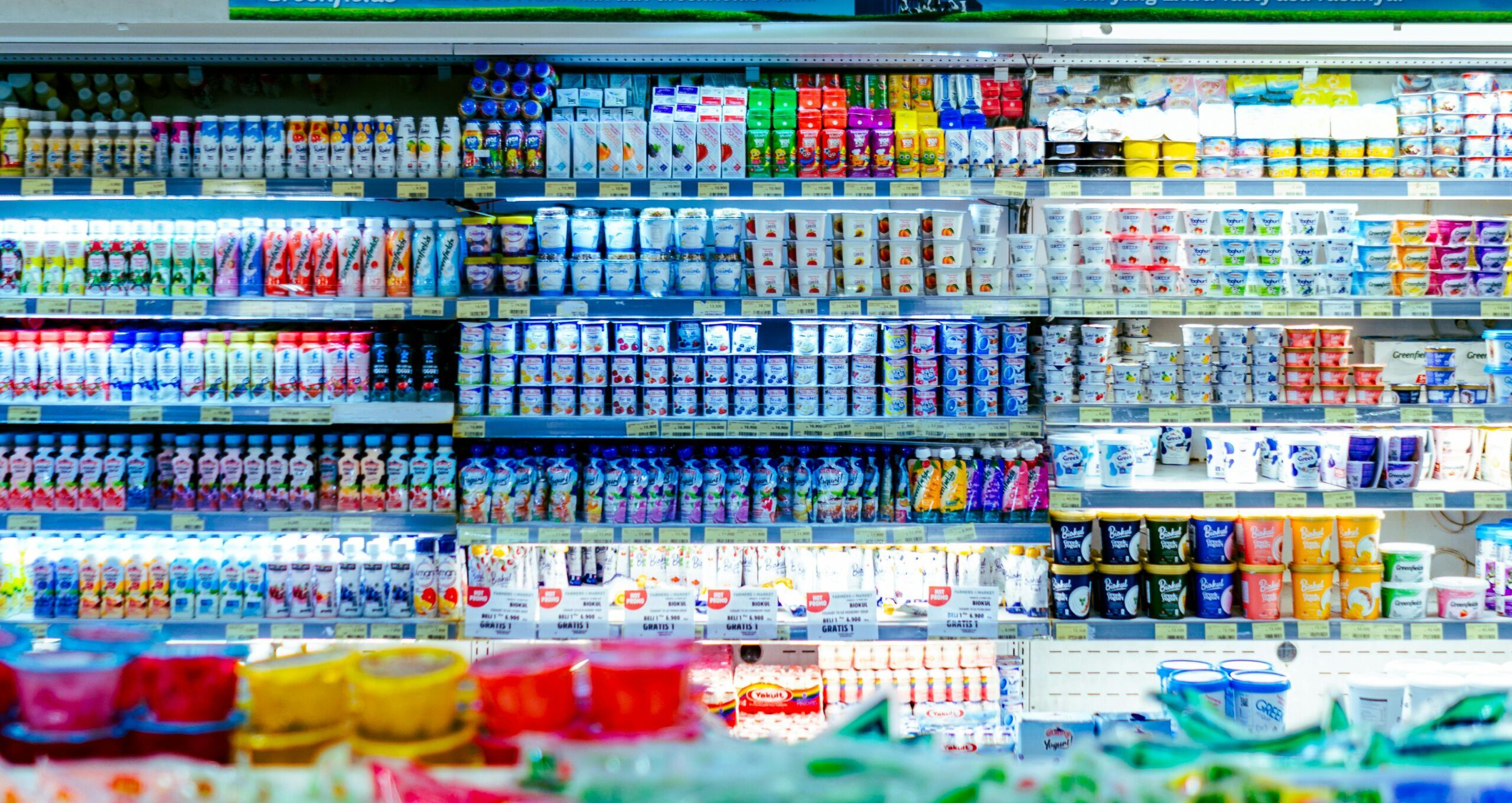 Vibrant shelves of diverse dairy products in a West Java supermarket.