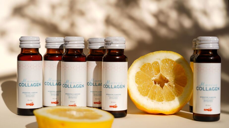 Collagen supplement bottles with lemon slice in bright light. Perfect for health and wellness themes.